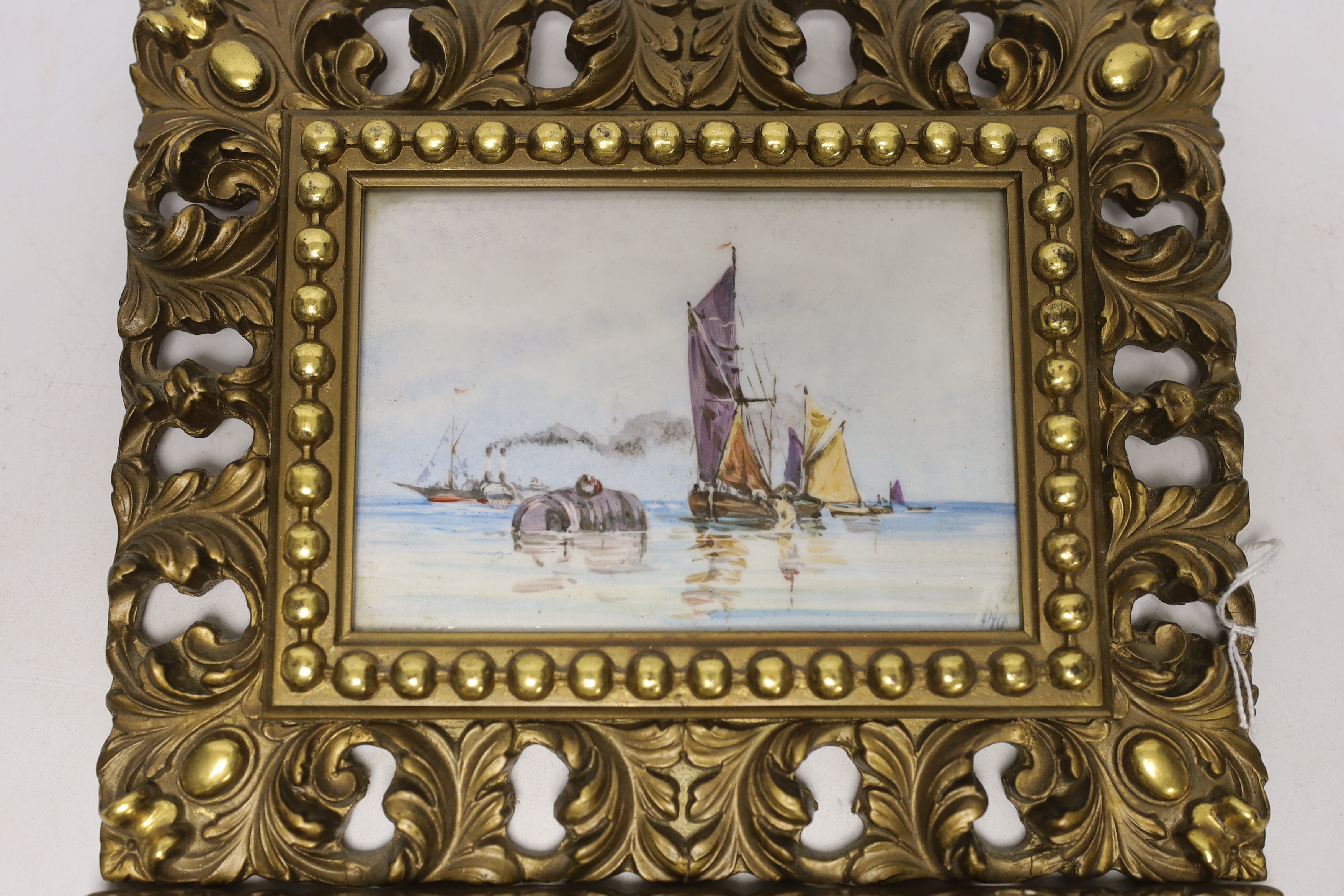 A pair of gilt framed painted porcelain plaques, indistinctly signed, 10x14cm excluding frame